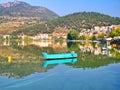 Lake Orestiada, Kastoria Greece. Reflections of boat and town on calm water