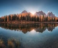 Lake with perfect reflection in water and orange trees at sunrise Royalty Free Stock Photo