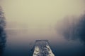 Lake pier, winter and heavy fog