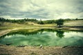 Lake in a pine forest in cloudy weather Royalty Free Stock Photo
