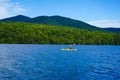 Kayaker enjoy summer day on Lake Placid in New York State`s Adirondack Mountains Royalty Free Stock Photo