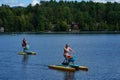 Visitors and locals enjoy summer day on Mirror Lake in Lake Placid, New York State Royalty Free Stock Photo