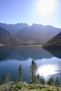Lake plansee at fall in austrian alps with sun Royalty Free Stock Photo