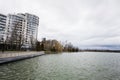 Lake promenade with glass building multistorey residental house on background