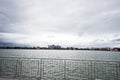 Lake promenade with glass building multistorey residental house on background