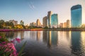 Lake with Purple Flowers in City Park under Skyscrapers at Sunrise Royalty Free Stock Photo