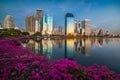 Lake with Purple Flowers in City Park under Skyscrapers at Twilight Royalty Free Stock Photo