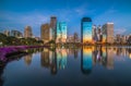 Lake with Purple Flowers in City Park under Skyscrapers at Twilight Royalty Free Stock Photo