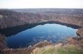 Lake in quarry with reflection of clouds