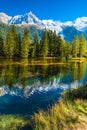 The lake reflected the snow-capped Alps