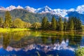 The lake reflected snow-capped Alps