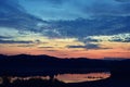 Lake reflecting colorfully clouds at sunset Royalty Free Stock Photo
