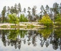 The lake reflects forest trees