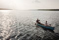 The lake always relaxes them. a young couple rowing a boat out on the lake. Royalty Free Stock Photo