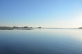 A lake or river with brown grasses and shore