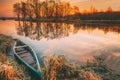 Lake River And Old Wooden Blue Rowing Fishing Boat At Beautiful Sunrise In Autumn Morning. Autumn Peaceful Landscape Royalty Free Stock Photo