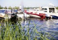 green grass lake water sunlight boats sky summer day bokeh background outdoor Royalty Free Stock Photo