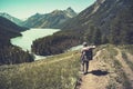 Lake with rocky ridge. Beautiful landscape. The tourist goes over the rocks on the shore of the lake. Altay Russia.