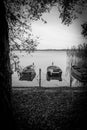 on a lake rowboats lying side by side on shore in water in black white Royalty Free Stock Photo