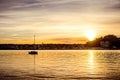 Lake with sail yacht and city in the sunset. Lago Maggiore and Arona Royalty Free Stock Photo