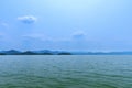 The lake scenery with mountains behind under the blue sky Royalty Free Stock Photo