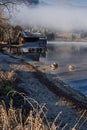 Lake schliersee gravel beach and boathouse in the morning sun