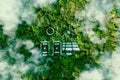 A lake in the shape of a solar, wind and energy storage system in the middle of a lush forest Royalty Free Stock Photo