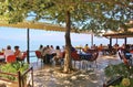 People in a restaurant with a panoramic view on Lake Shkodra. Albania.