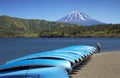 Lake Saiko with blue boats and Mt. Fuji in the background in Japan.