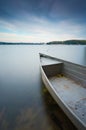 Lake shore with moored boat. Long exposure Royalty Free Stock Photo