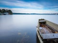 Lake shore with moored boat. Long exposure Royalty Free Stock Photo