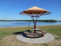 Lake shore summer landscape and bench blue sky background Royalty Free Stock Photo