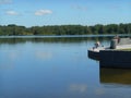 Lake shore summer landscape and fisherman in the Minsk Belarus blue sky background Royalty Free Stock Photo