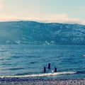 Lake shore with three posts in water with waves