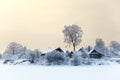 Lake shore with timber houses at winter season with sunset sky