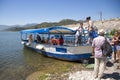 Tourists board a pleasure boat