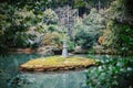 Lake and stone pagoda at Kinkakuji temple in Kyoto, Japan Royalty Free Stock Photo
