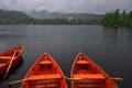 Lake StrbskÃÂ© pleso and a hotel in the High Tatras, Slovakia. Orange boats in front. The ski-jumping hill on the left. It`s Royalty Free Stock Photo