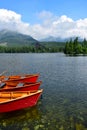 Lake StrbskÃÂ© pleso and a hotel in the High Tatras, Slovakia. Orange boats in front