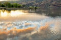 Lake with sunset sky reflection, and houses and foothills in the distance Snake River on the border of Idaho and Washington states