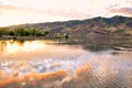 Lake with sunset sky reflection, and houses and foothills in the distance Snake River on the border of Idaho and Washington states