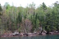 The Lake Superior shoreline in Bayfield, Wisconsin, lined by a forest with Evergreen and Birch trees, in the spring Royalty Free Stock Photo