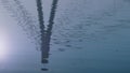 Lake surface reflect bridge autumn day. Silhouette modern tower on water.