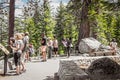Lake Tahoe - Tourists at overlook checking out map and taking selfies over the Lake with evergreen trees in the