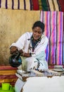 Lake Tana, Ethiopia - Feb 05, 2020: Zege Peninsula in Lake Tana. Young woman is preparing a coffee ceremony