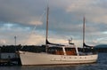 Small white sailing boat moored at dock on lake at dust Royalty Free Stock Photo