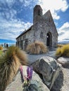 Lake Tekapo Church amidst vibrant lupins in New Zealand's breathtaking landscape Royalty Free Stock Photo