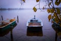 a lake there are several rowing boats on the shore and they are chained and the water is mirror-smooth Royalty Free Stock Photo