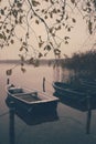 a lake there are several rowing boats on the shore and they are chained and the water is mirror-smooth Royalty Free Stock Photo