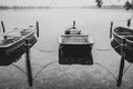 a lake there are several rowing boats on the shore and they are chained and the water is mirror-smooth Royalty Free Stock Photo